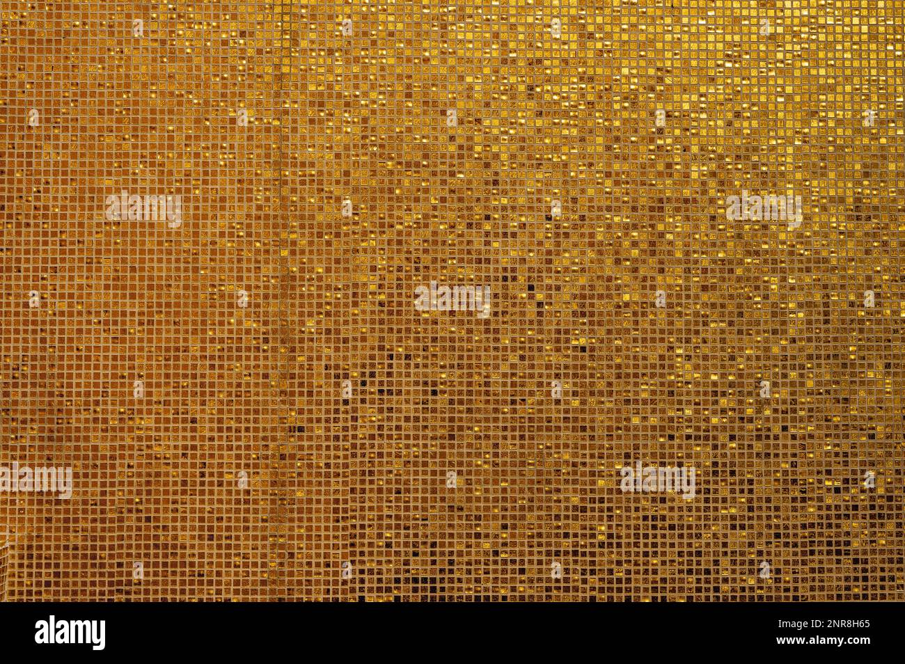Piccola struttura in piastrelle d'oro. Piccole piastrelle dorate disposte per adattarsi allo sfondo. Sfondo mosaico dorato lucido con piastrelle quadrate smaltate in file Foto Stock