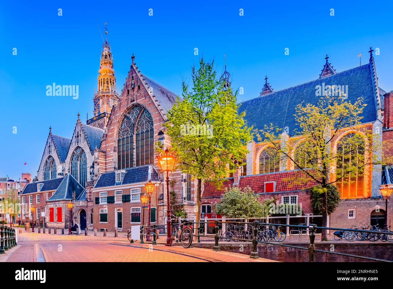 Amsterdam, Paesi Bassi. L'Oude Kerk al crepuscolo. Foto Stock