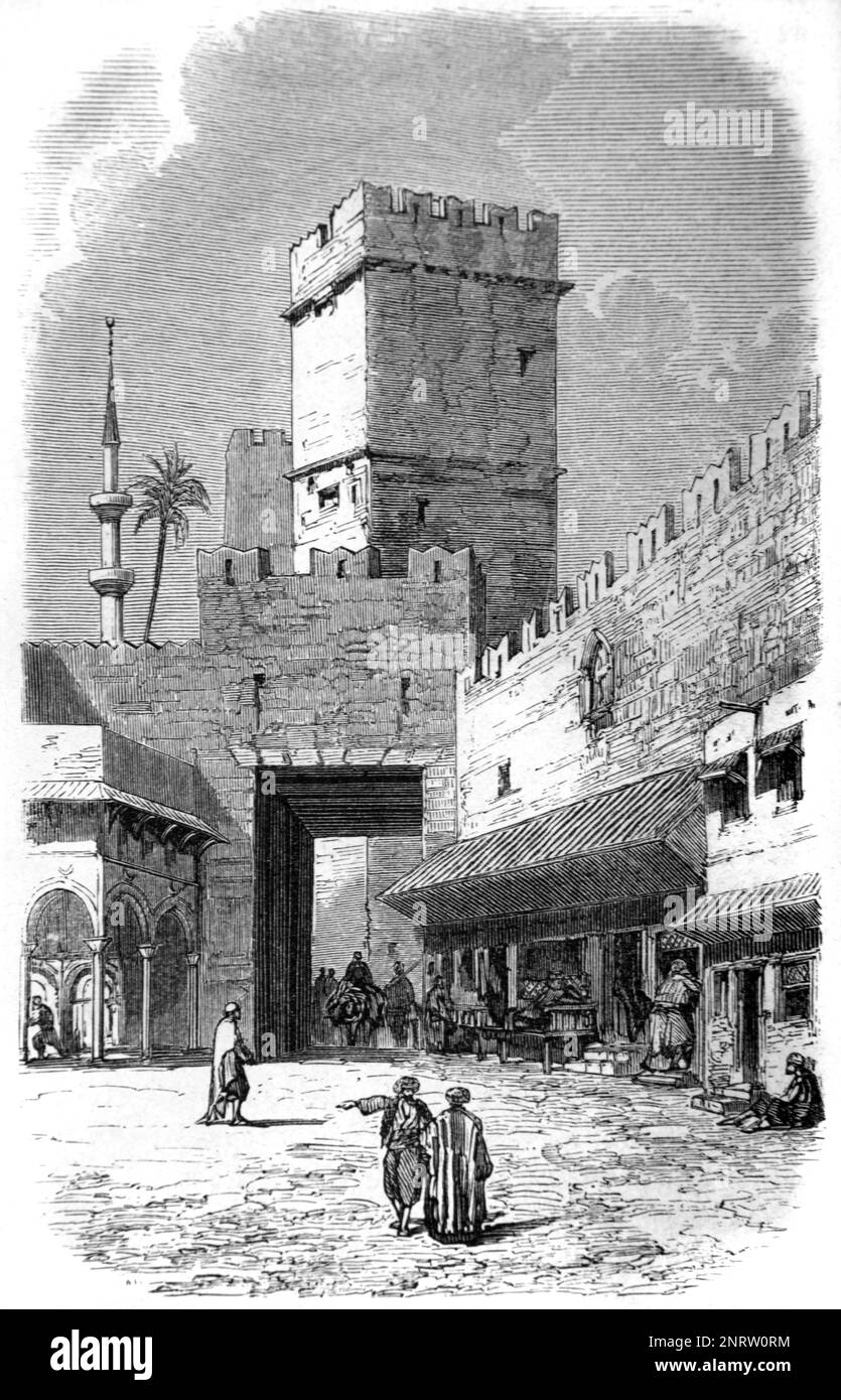 Porta della città o ingresso della città al Bazaar o al mercato, con torre di avvistamento in pietra e le mura della città di Rodi, Grecia. Vintage Engraving o Illustrazione 1862 Foto Stock