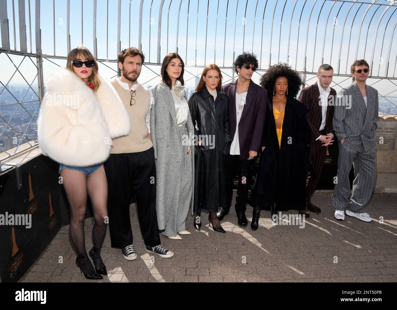 The cast of the Prime Video television series "Daisy Jones & The Six," from left, Suki Waterhouse, Sam Claflin, Camila Morrone, Riley Keough, Sebastian Chacon, Nabiyah Be, Will Harrison and Josh Whitehouse visit the Empire State Building on Monday, Feb. 27, 2023, in New York. (Photo by Charles Sykes/Invision/AP) Foto Stock