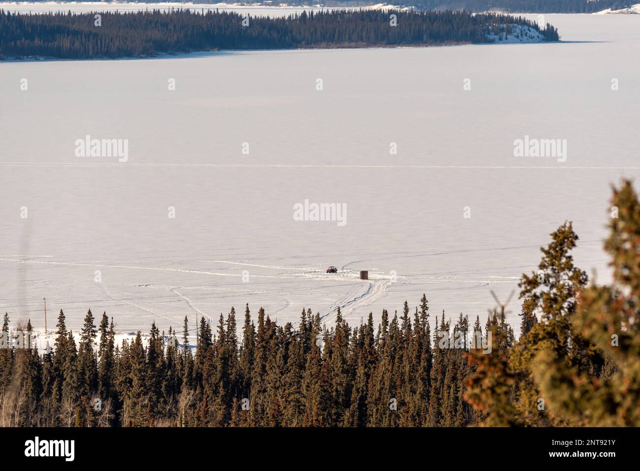 In inverno, vista sulla natura selvaggia del lago Marsh al di fuori di Whitehorse nel territorio dello Yukon, con acqua ghiacciata e montagne innevate. Foto Stock