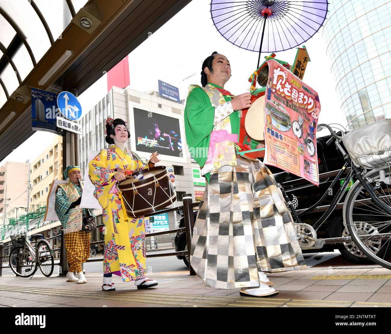 Chindon'ya performers march around the street to promote a festival in ...