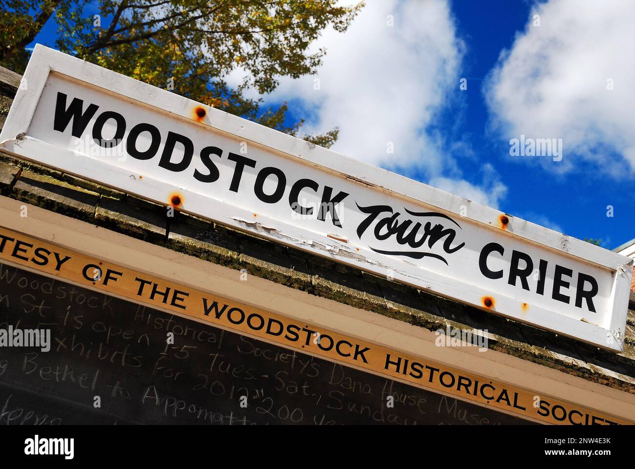 Il Woodstock Town Crier nota tutte le notizie e gli eventi della piccola città su una lavagna nel verde villaggio Foto Stock