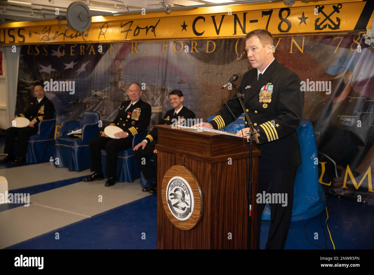 Il capitano Mac Harkin, Commodore di Destroyer Squadron 2 (DESRON 2) parla durante una cerimonia di cambio di comando a bordo della prima portaerei della classe USS Gerald R. Fords (CVN 78), 17 febbraio 2023. Harkin, fuggendo dalla sua carica di vice Commodore, DESRON 2, riviveva il capitano Stefan Walch che guidava DESRON 2 dal dicembre 2021. Foto Stock