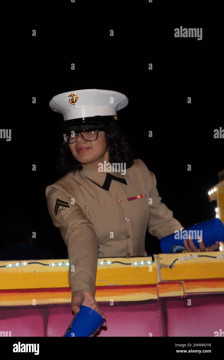 Jessica Alvarado Duran, ufficiale non commissionato dell’ufficio di coordinamento dell’aviazione, 4th Marine Aircraft Wing, esce coppe, a bordo del galleggiante di Krewe of Selene Slidell, Louisiana, 17 febbraio 2023. Il Krewe di Selene prende il nome dalla dea greca della luna ed è stato fondato da un gruppo di donne professionali locali a Slidell. Le donne sono state invitate a essere le grandi Marshalls per celebrare quest’anno il tema: “25 anni di donne che stimolano le donne”. Foto Stock