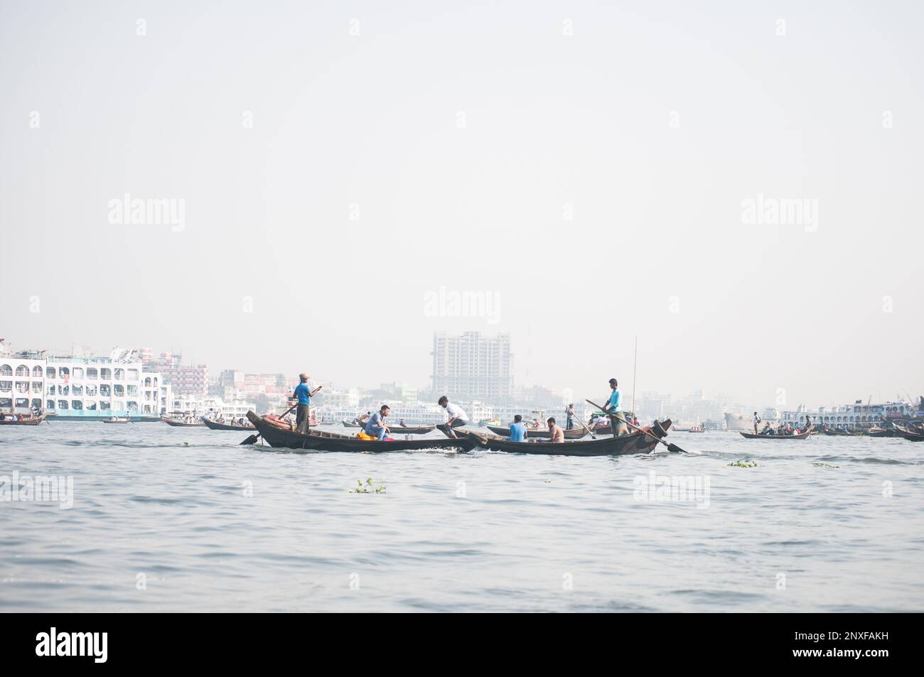 Foto della barca sull'acqua a Sadarghat e vista sulla strada. Alcuni venditori di fiori a Dhaka, Bangladesh Foto Stock