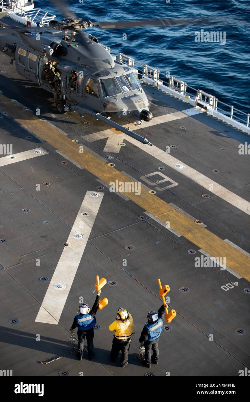 230122-N-XP477-1235 OCEANO PACIFICO (22 gennaio 2023) – i marinai trattengono i cunei e le catene a bordo del vettore d'assalto anfibio USS Tripoli (LHA 7) 22 gennaio 2023. Tripoli sta conducendo operazioni di routine nella U.S. 3rd Fleet. Foto Stock