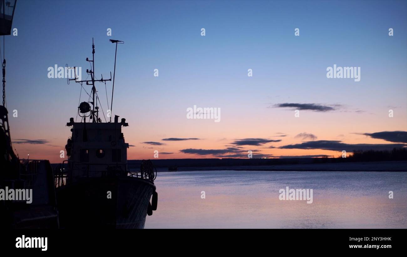 Bellissimo paesaggio nave sullo sfondo del tramonto orizzonte mare. Fermo. Marina sullo sfondo del tramonto sul mare. Nave al molo sullo sfondo del bellissimo tramonto Foto Stock
