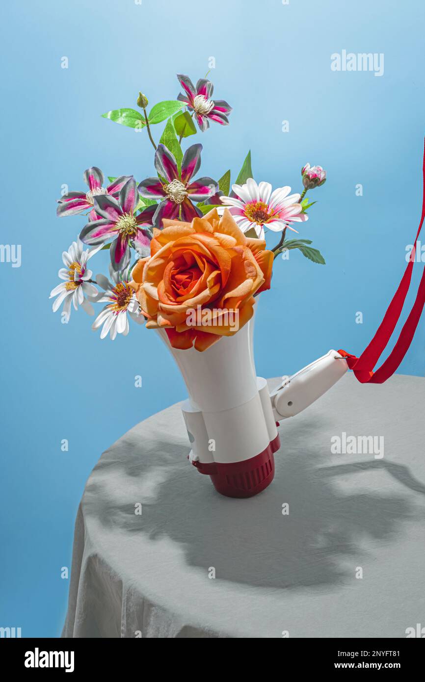 Bouquet di rosa e bianco con fiori in fiore beige con foglie verdi in altoparlante bianco sul tavolo su sfondo blu Foto Stock