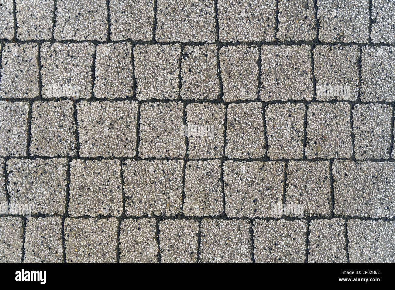 Struttura del pavimento. Sfondo astratto di lastre di pavimentazione grigie di piccola pietra, primo piano. Foto Stock