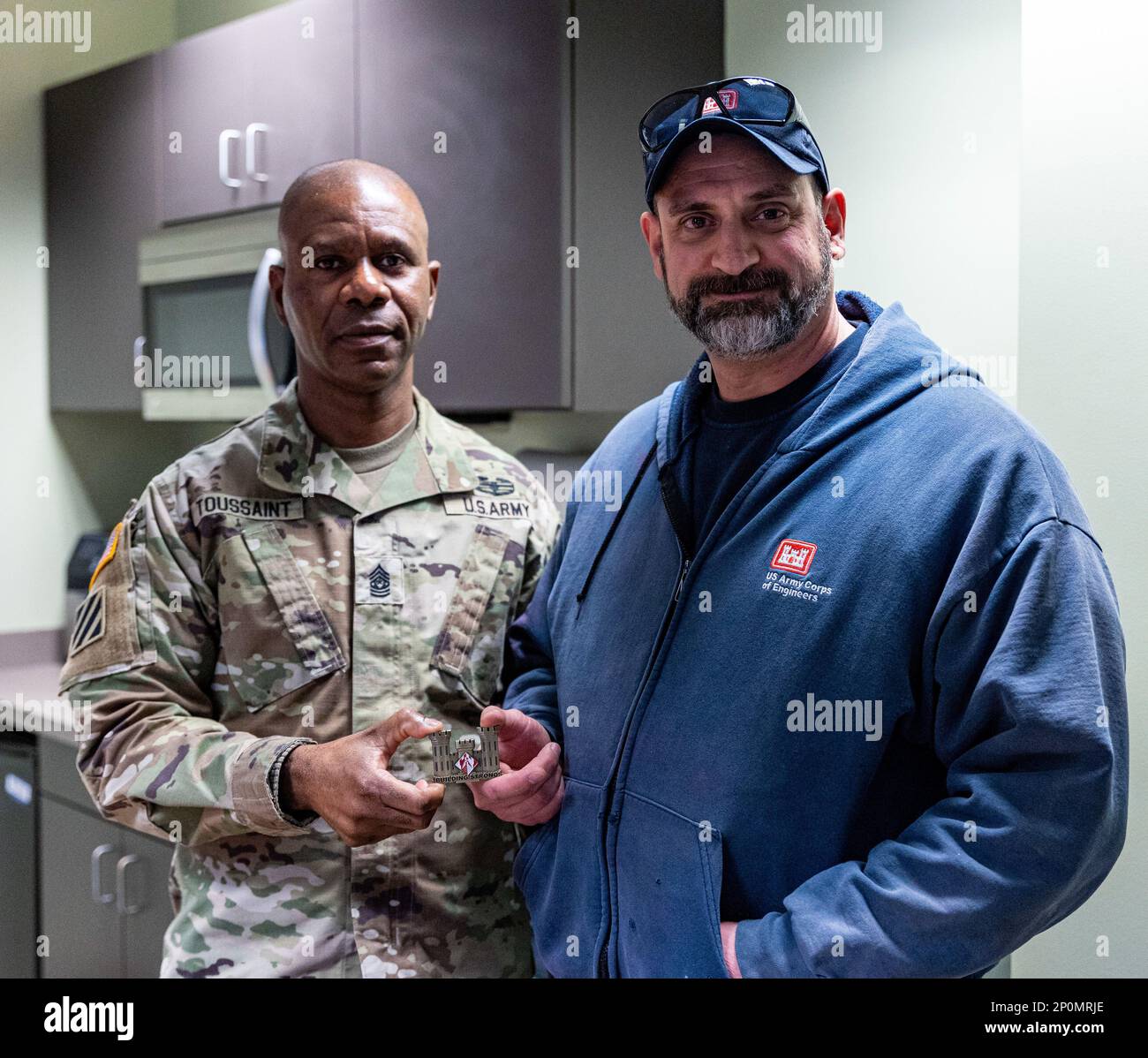 Comando Sgt. Maj Patrickson Toussaint, il consulente senior più alto arruolato per gli Stati Uniti Army Corps of Engineers, presenta una moneta di comando a Michael Ritchey, meccanico di attrezzature per il distretto di Pittsburgh, presso le chiuse del fiume Monongahela e la diga 4 a Charleroi, Pennsylvania, il 30 gennaio 2023. I leader militari presentano monete personalizzate ai membri dei servizi civili e militari per mostrare apprezzamento per un lavoro ben fatto degno di riconoscimento. Toussaint ha trascorso diversi giorni a parlare con i dipendenti di tutto il distretto per avere una prospettiva migliore delle loro responsabilità e dei loro ruoli nel sostenere la missione del corpo Foto Stock