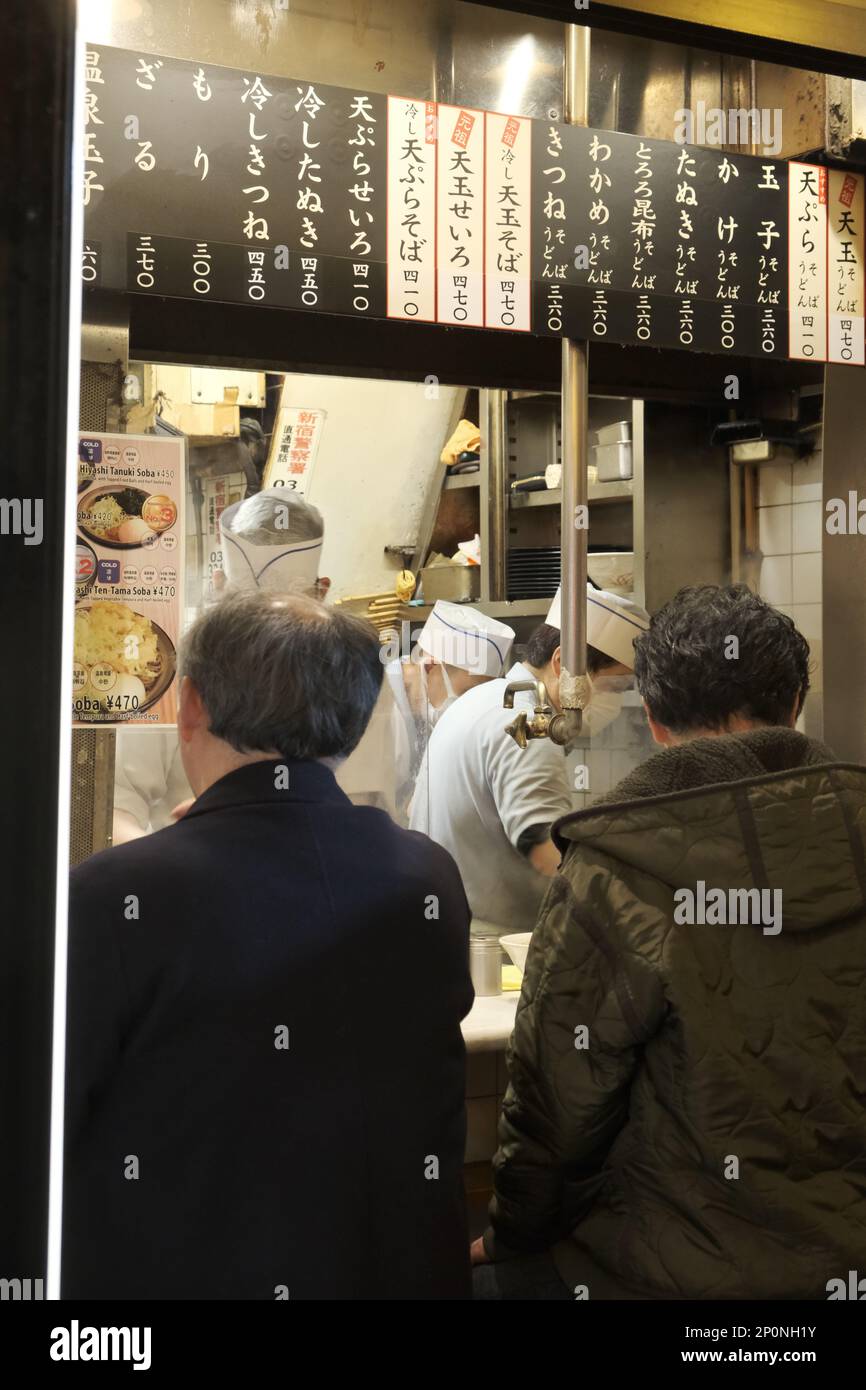 Persone che mangiano in piccoli ristoranti vicoli a Shinjuku, Giappone. Foto Stock