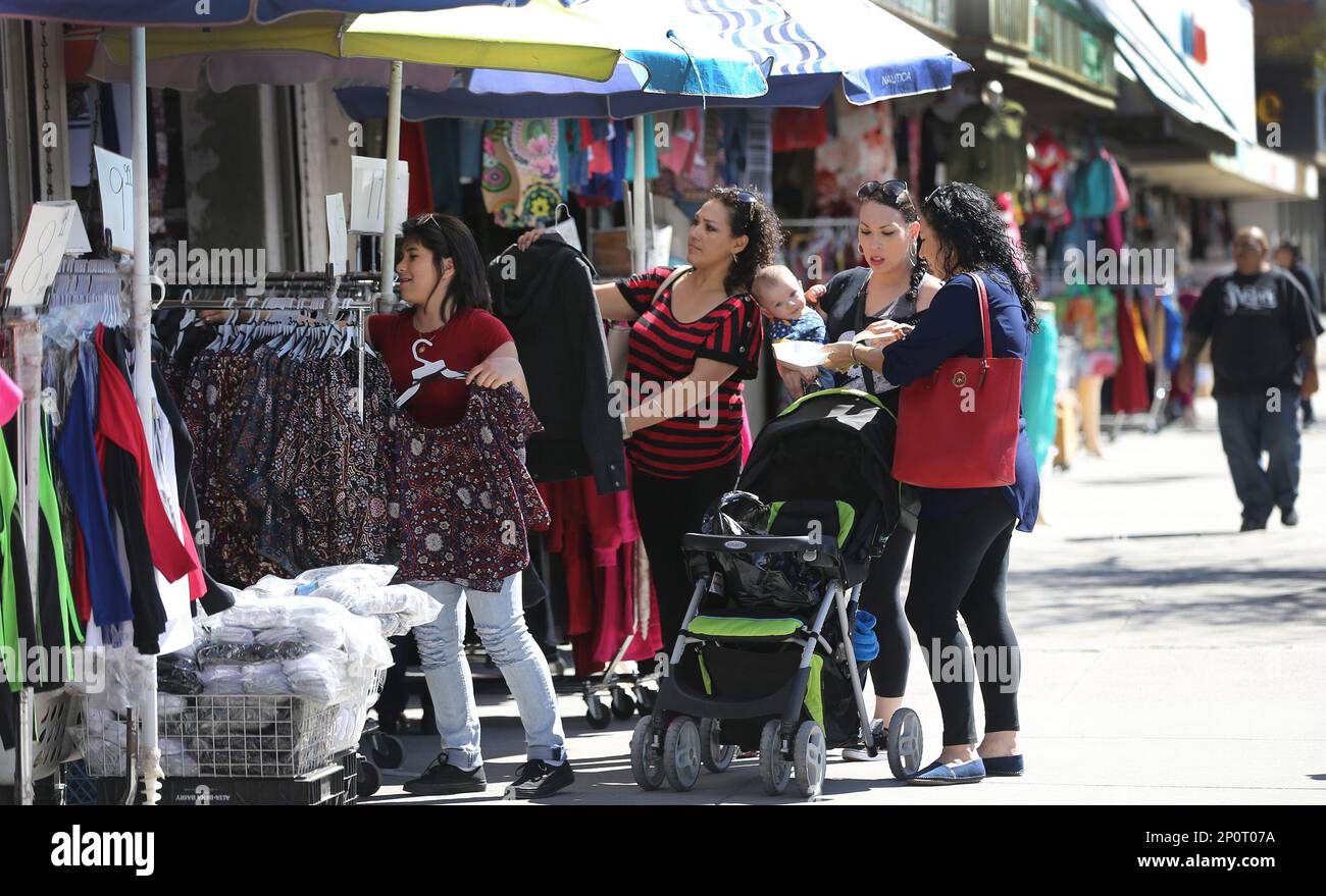 Shoppers go through the racks at one of the many stores on El Paso