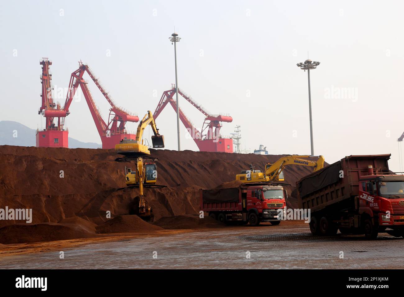 LIANYUNGANG, CINA - 4 MARZO 2023 - il minerale di ferro importato viene scaricato e accatastato nel porto di Lianyungang, nella provincia di Jiangsu della Cina orientale, il 4 marzo 202 Foto Stock