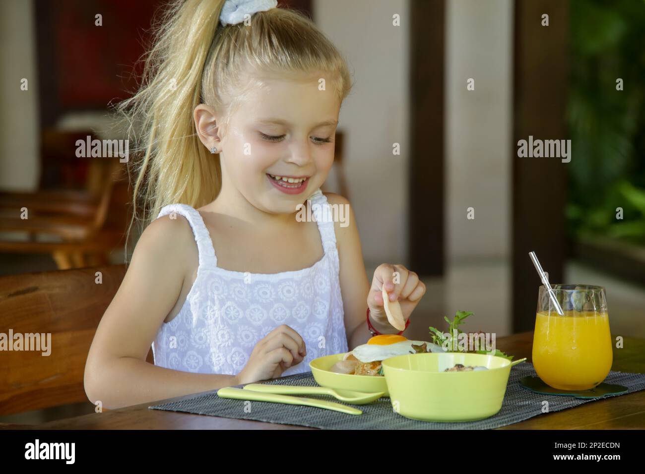 Adorabile ragazza di 5 anni che fa colazione al ristorante Foto Stock