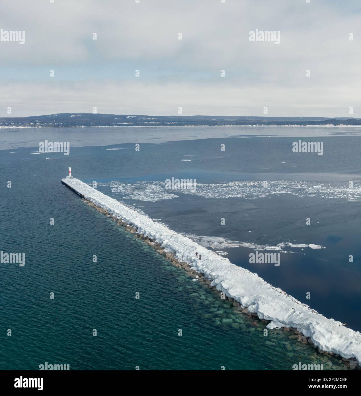 Vista aerea della breakwall marina in inverno con due persone a piedi Foto Stock