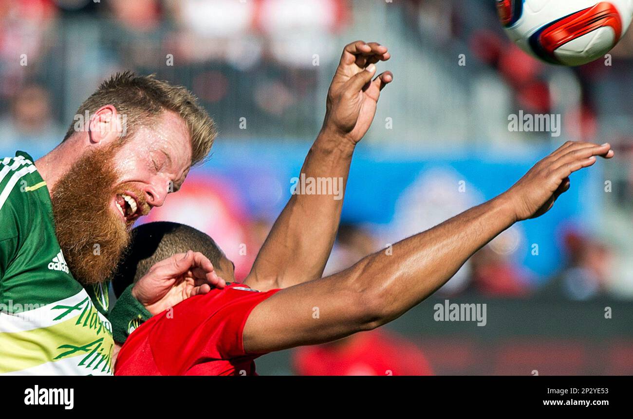 Toronto FC forward Luke Moore, right, battles for the ball against Portland Timbers defender Nat Borchers, left, during first-half MLS soccer game action in Toronto, Saturday, May 23, 2015. (Nathan Denette/The Canadian Press via AP) MANDATORY CREDIT Foto Stock