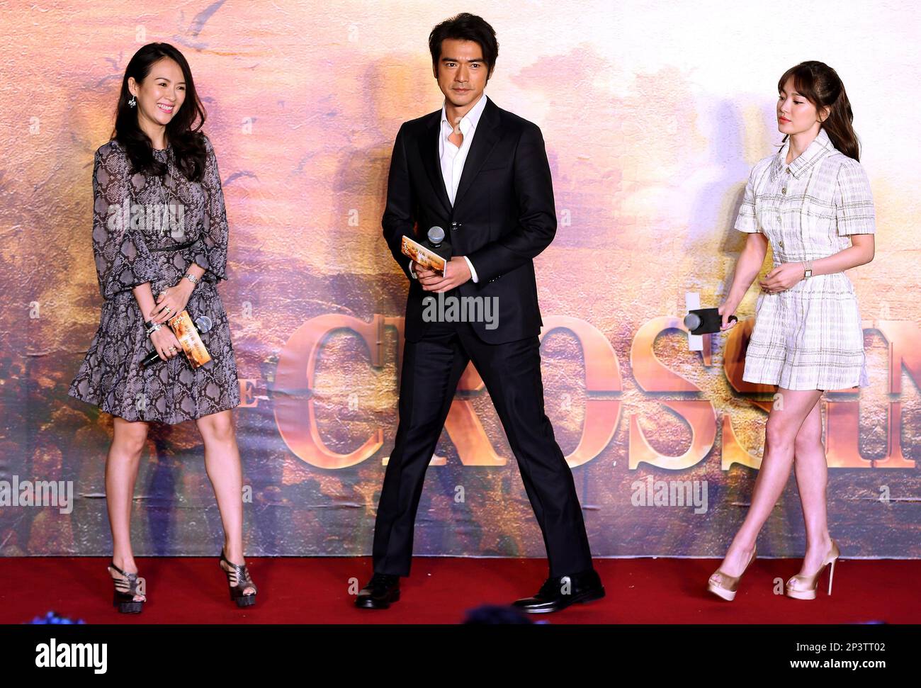 From left, Chinese actress Zhang Ziyi, Japanese actor Takeshi Kaneshiro, and Korean actress Song Hye-kyo, at a press conference for the star-studded movie The Crossing in Beijing, China Thursday Nov. 27, 2014. (AP Photo) CHINA OUT Foto Stock