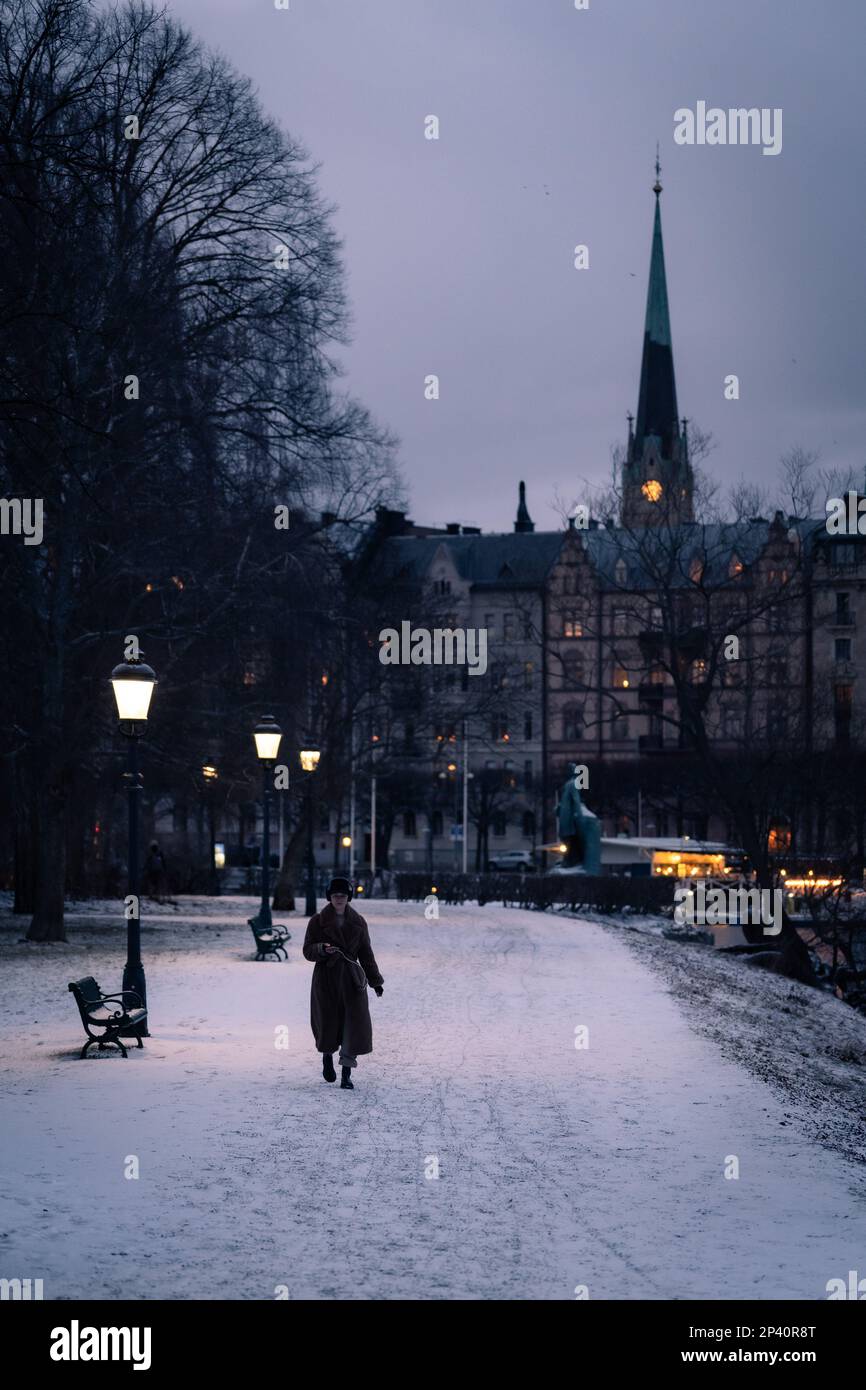 Donna che cammina da sola di notte a Stoccolma, Svezia Foto Stock