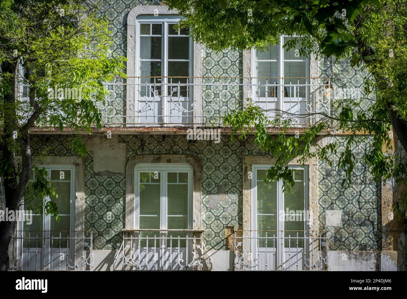 Setúbal, Portogallo, alberi verdi, tempo di primavera, orante azulejo tilework su una casa Foto Stock