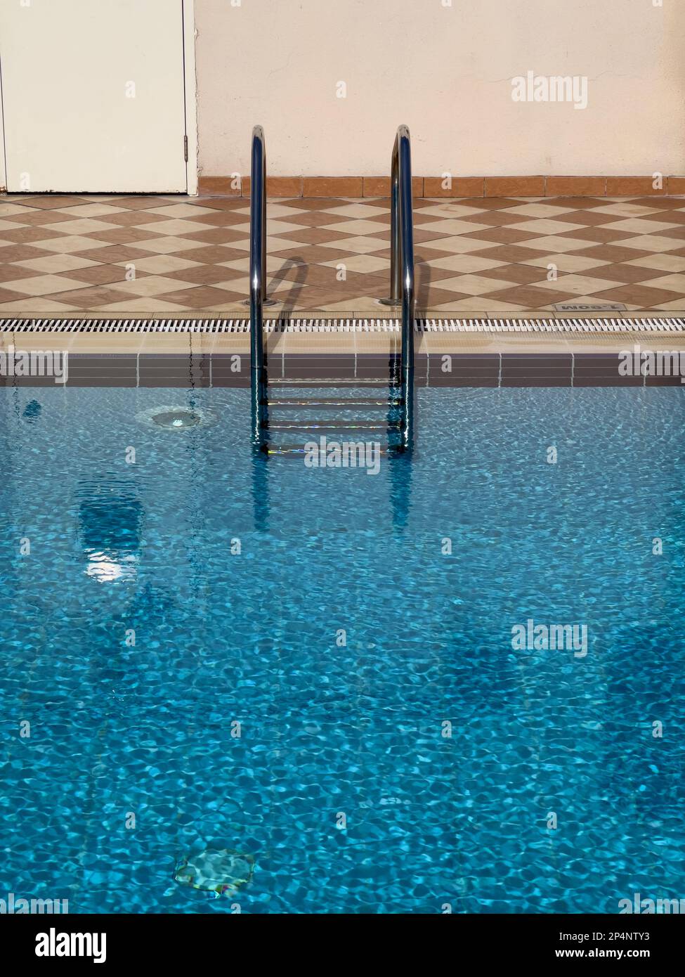 piscina all'aperto con acqua blu e lager in una calda giornata estiva. concetto tropicale. Foto Stock