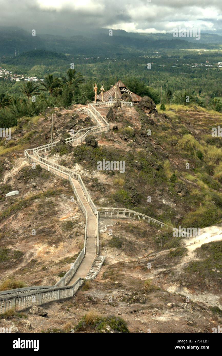 Una vista del paesaggio di Minahasa è vista dalla scalinata che conduce ad un terreno pianeggiante della collina dove i luoghi di culto di tutte le religioni riconosciute in Indonesia sono costruiti su Bukit Kasih (collina dell'amore), una popolare destinazione turistica religiosa situata nel villaggio di Kanonang, Kawangkoan occidentale, Minahasa, Sulawesi settentrionale, Indonesia. Dedicato a tutti i credenti e devoti, promuovendo gli spiriti dell'amore, della pace e della tolleranza; Bukit Kasih fu iniziato all'inizio del 2000, quando Adolf J. Sondakh fu il governatore della provincia di Sulawesi settentrionale. E' stata considerata una nobile iniziativa di pace. Foto Stock