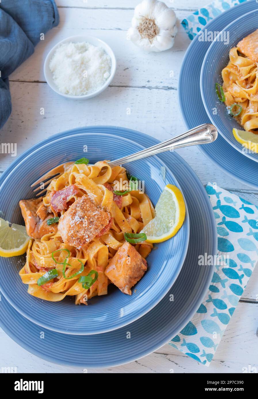 Salmone con pasta e salsa di pomodoro sui piatti Foto Stock
