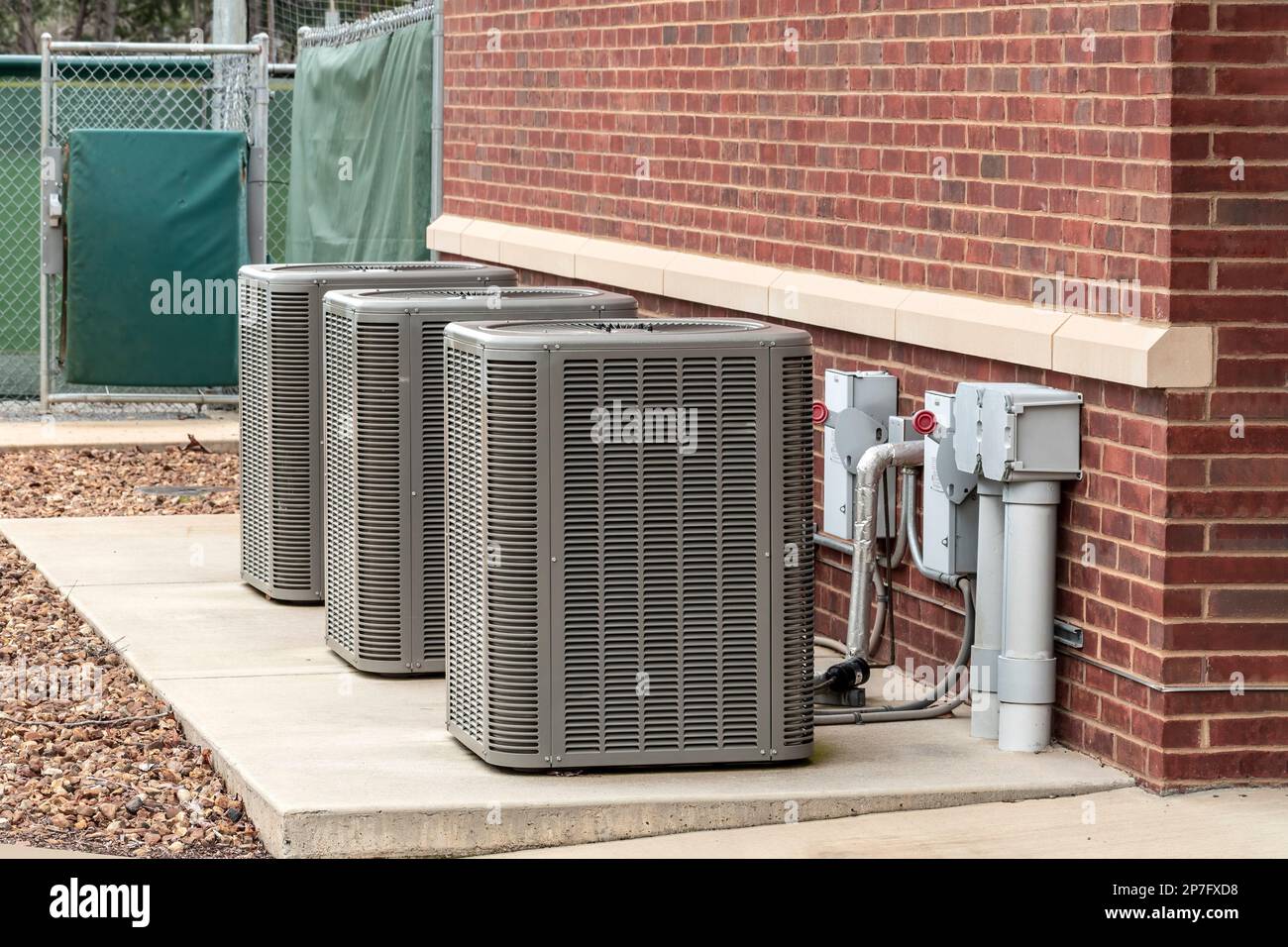Immagine orizzontale di tre condizionatori d'aria all'esterno di un complesso sportivo. Foto Stock
