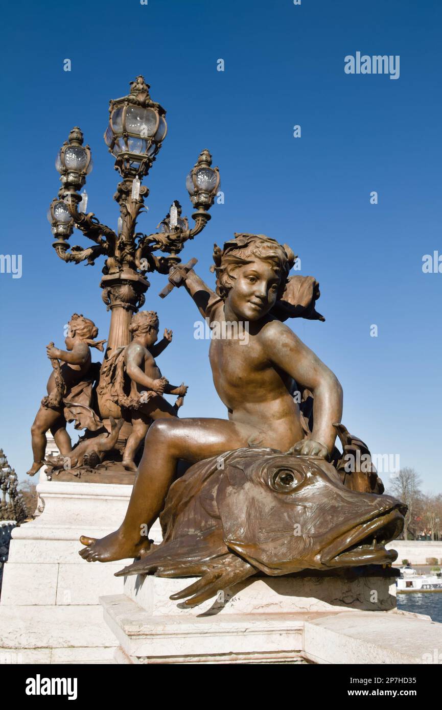 Statue sul Pont Alexandre III con la statua di Genie au Trident di Un cherubino su un pesce, Parigi Francia Foto Stock