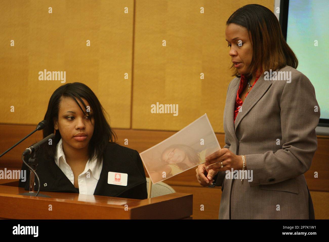 Tiffani Nixon, right, 20, looks at a picture of her friend Jasmine Lynn ...