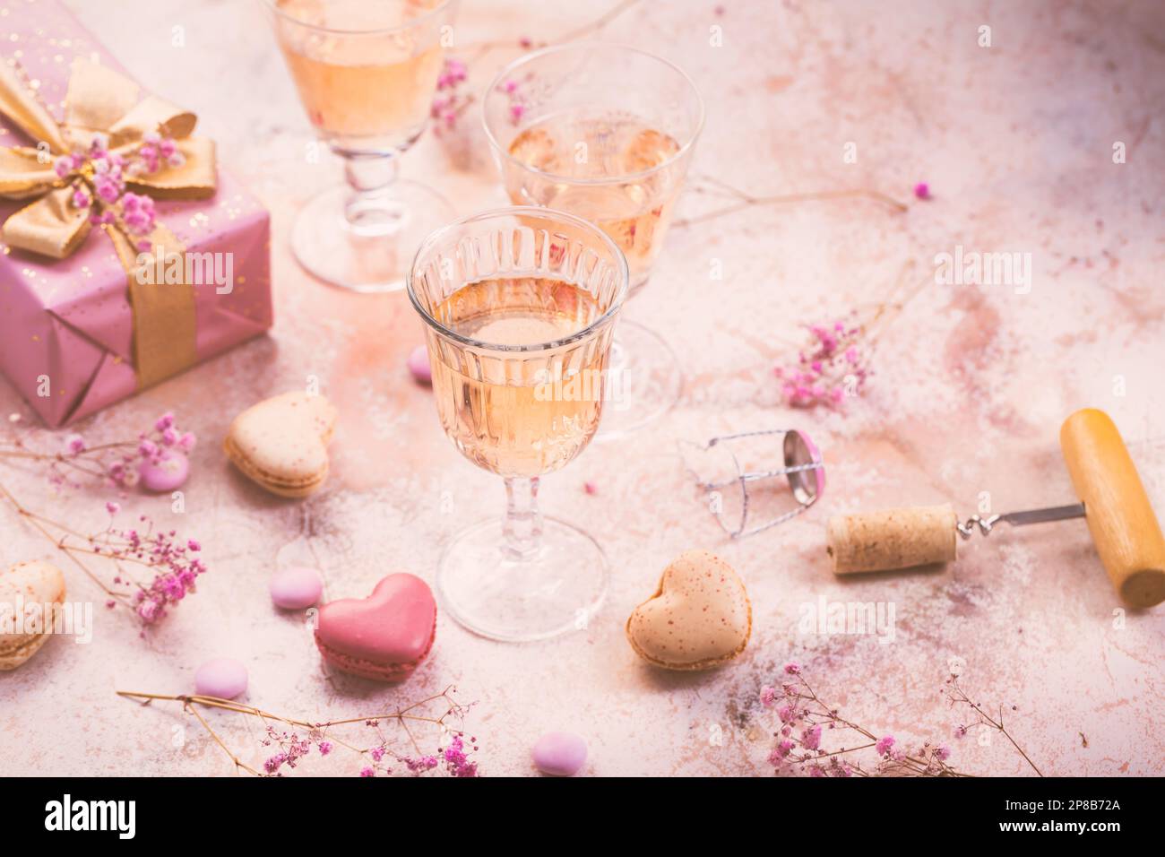 Vino frizzante alle rose, macaron francesi e scatola di cioccolatini per San Valentino, la giornata delle mamme o il compleanno Foto Stock