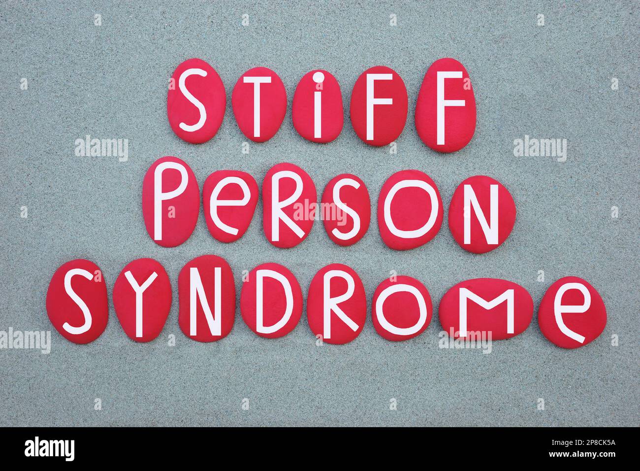 Sindrome di persona rigida, sps, raro, disturbo neurologico progressivo, testo composto da lettere di pietra dipinte di rosso su sabbia verde Foto Stock