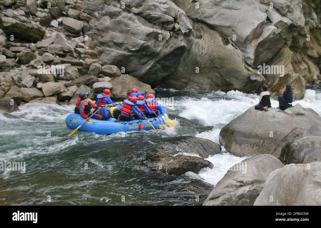 In this photo taken on Saturday, Feb. 21, 2009, village children watch ...