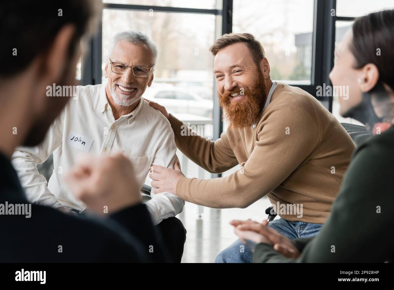 Persone positive con dipendenza da alcol seduto in cerchio nel centro di riabilitazione, immagine stock Foto Stock