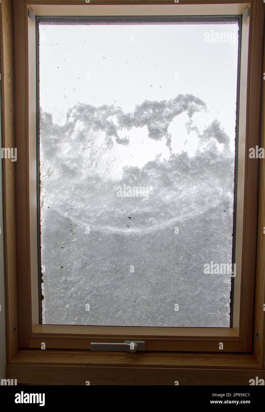 Guarda attraverso un lucernario coperto di neve sciogliente Foto Stock