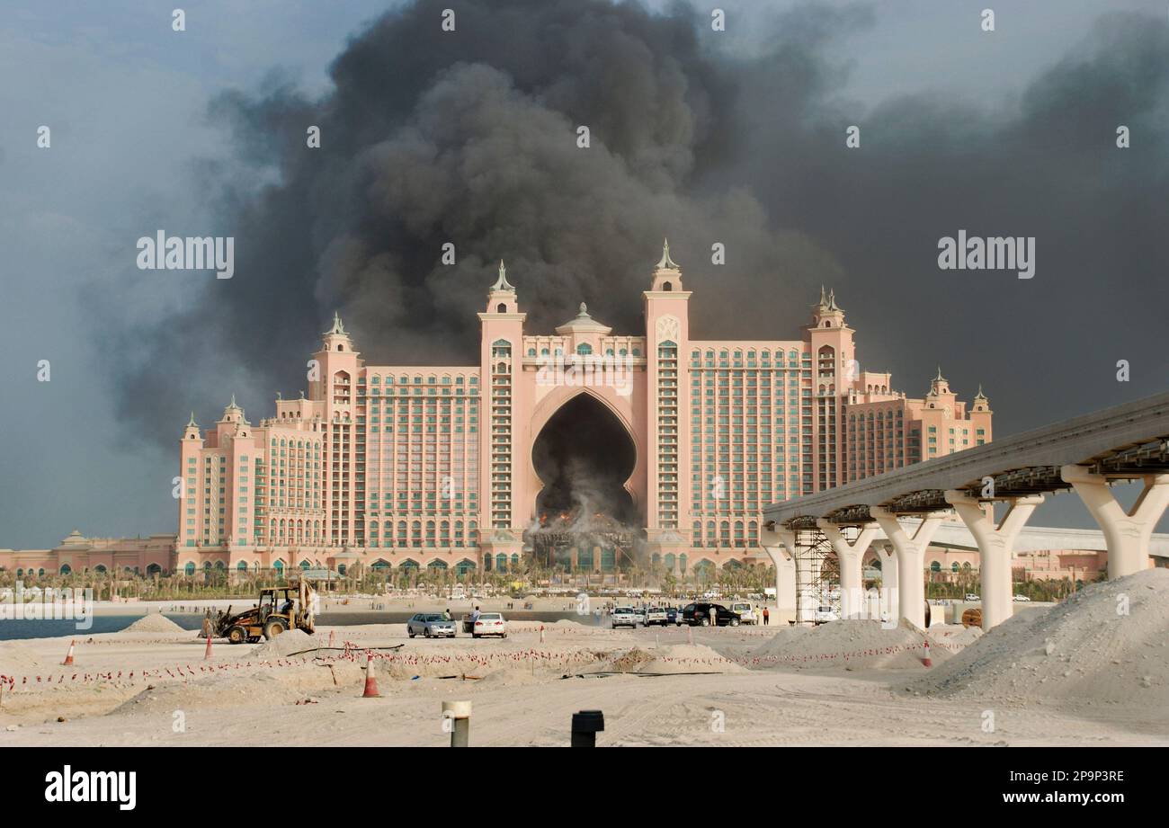Smoke fills the sky as a fire burns in the five-star Atlantis hotel ...