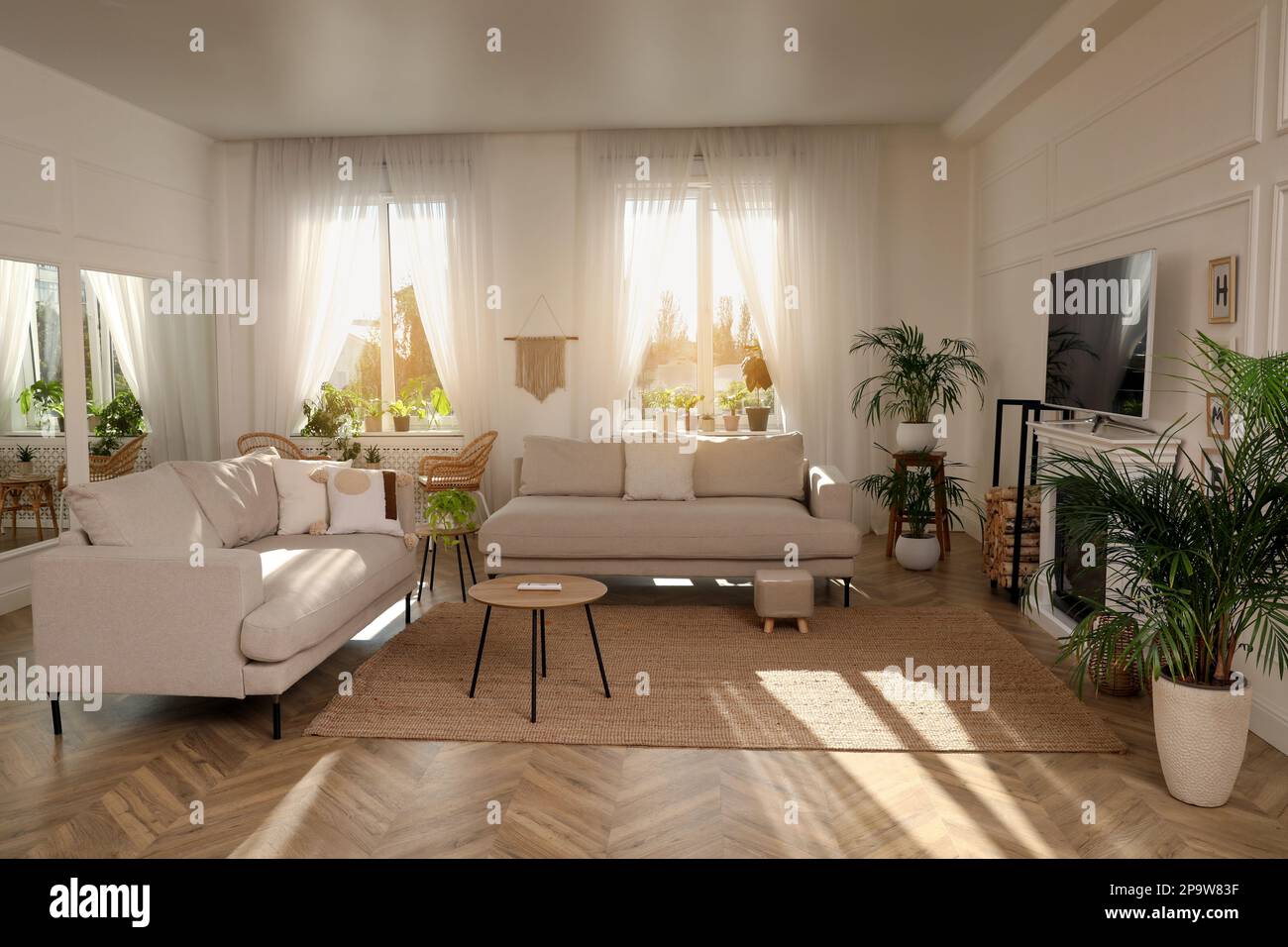 Elegante soggiorno con comodi divani, TV moderna e caminetto. Design degli interni Foto Stock