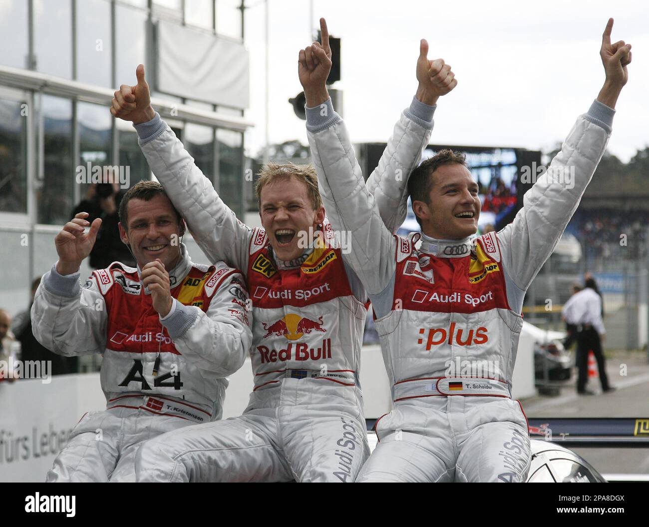 Sweden's Mattias Ekstroem of Audi Sport Team, center, celebrates his victory, with second placed Timo Scheider from Germany, and third placed Tom Kristensen from Denmark during the first race of the German Touringcar Championship, DTM, at the Hockenheim race track in Hockenheim, southern Germany on Sunday, April 13, 2008. (AP Photo/Daniel Maurer) Foto Stock