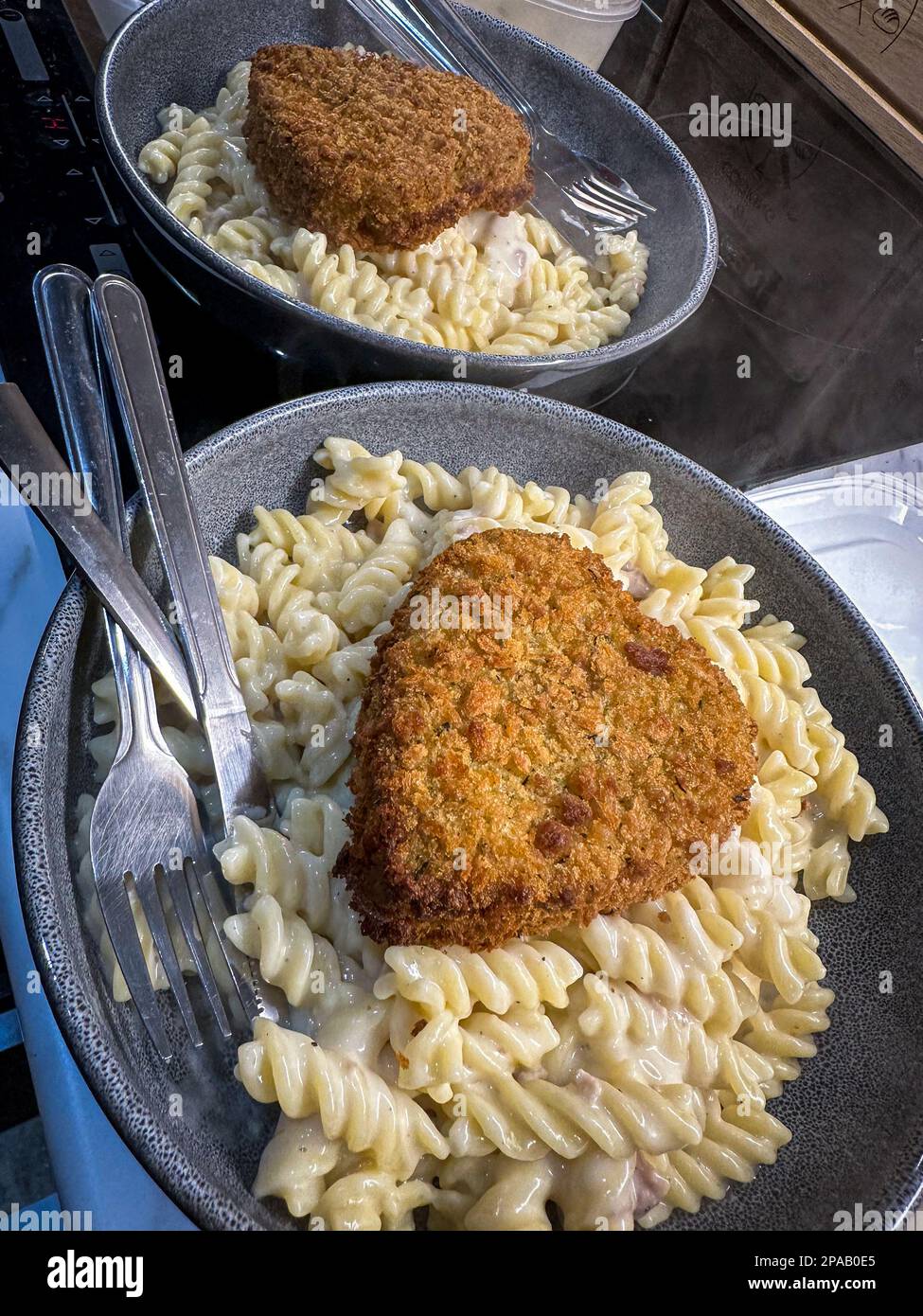 Alcuni carbonara fusilli pasta con un cuore d'amore crocchette a forma di cuore non ho potuto resistere a cucinare per me e la mia ragazza dopo alcuni giorni di sentirsi suicida a Foto Stock