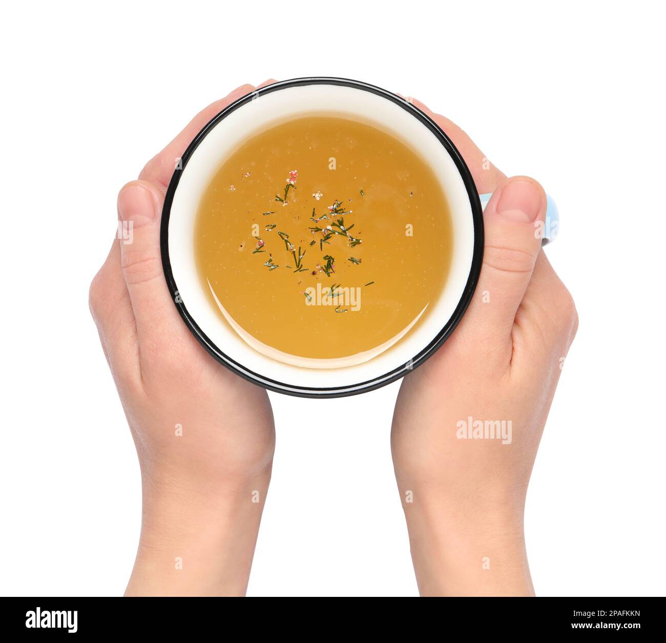 Donna con tazza di caldo delizioso bouillon su sfondo bianco, vista dall'alto Foto Stock