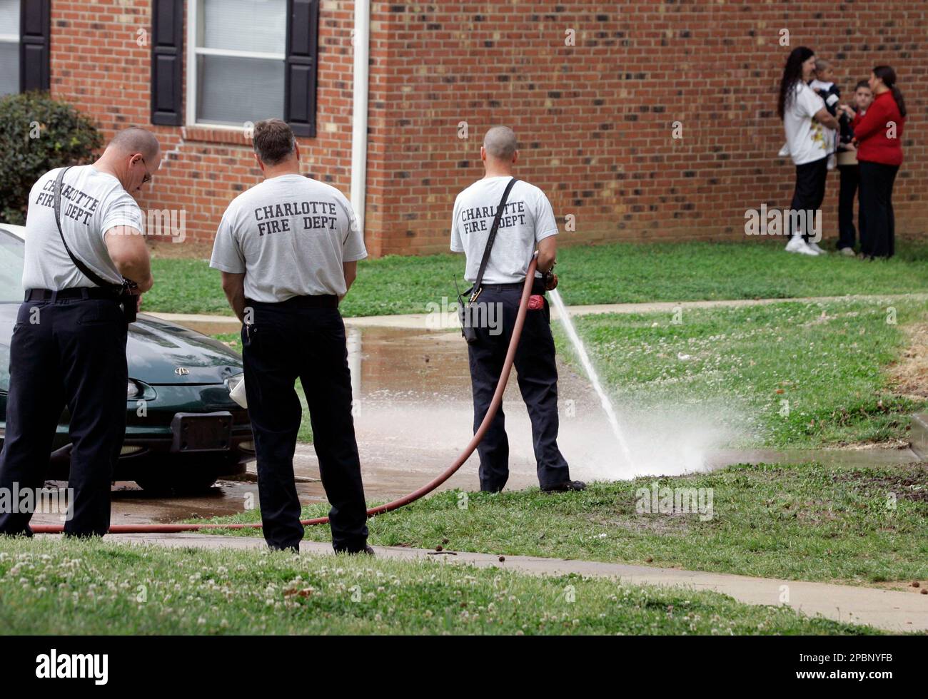 Members of the Charlotte Fire Department clean the scene where two ...