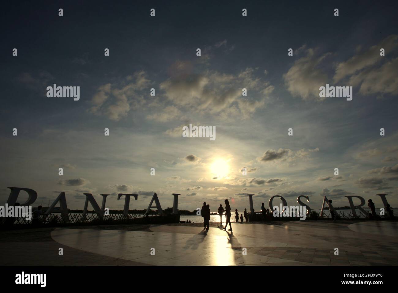 I cittadini e i turisti hanno un pomeriggio libero presso la piattaforma ricreativa della spiaggia di Losari nella zona costiera di Makassar City, Sulawesi Sud, Indonesia. Una delle 30 città costiere dell'Indonesia che si stima sia potenzialmente colpita dall'aumento del livello del mare, Makassar è stata considerata dai ricercatori e dagli scienziati una città con notevoli problemi ambientali e sociali; principalmente come risultato della condizione geomorfologica e della politica di utilizzo del territorio e di sviluppo costiero, in particolare i progetti di bonifica attualmente condotti dai governi provinciali. Foto Stock