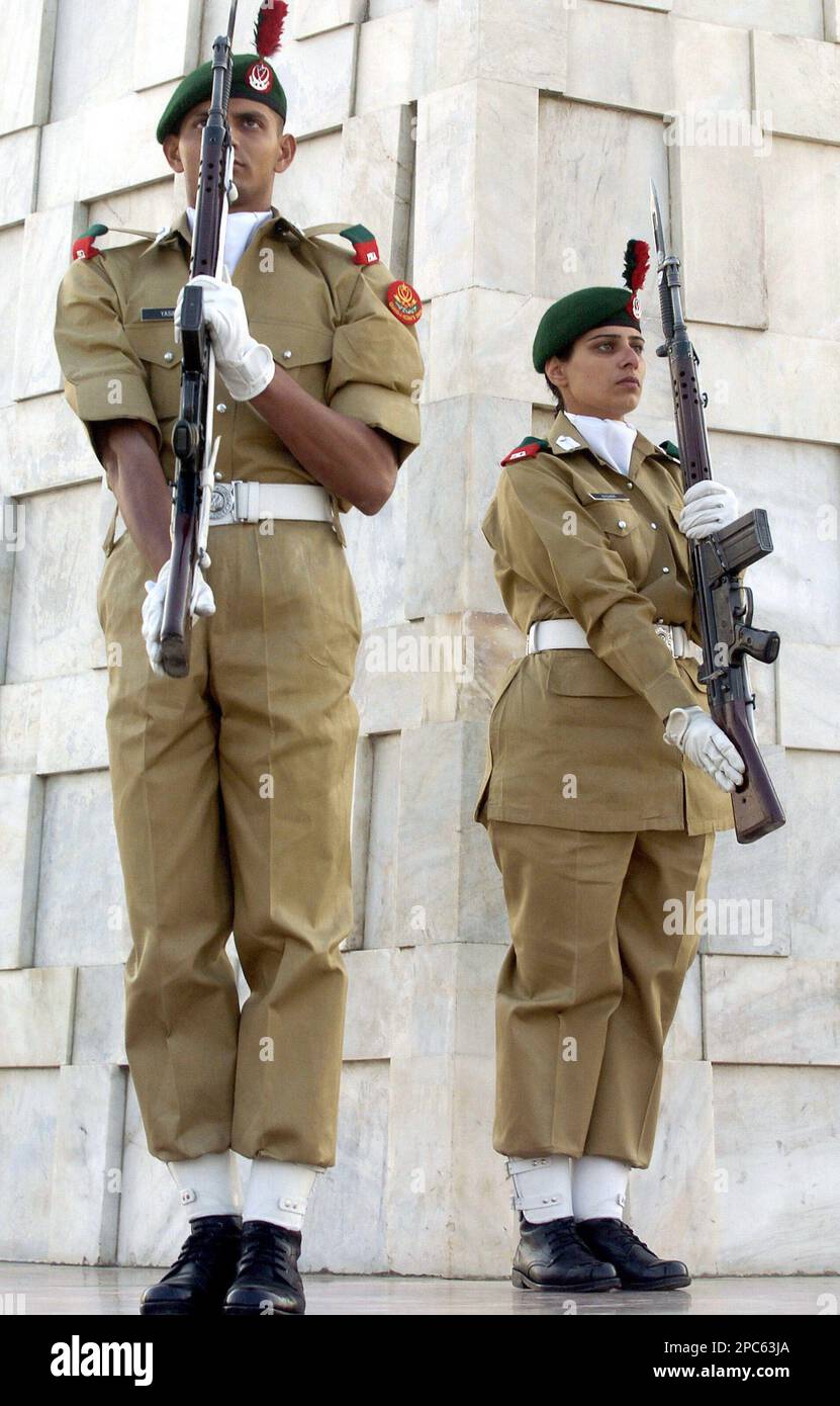 A female cadet of Pakistan Army stands guard with her male colleague at ...