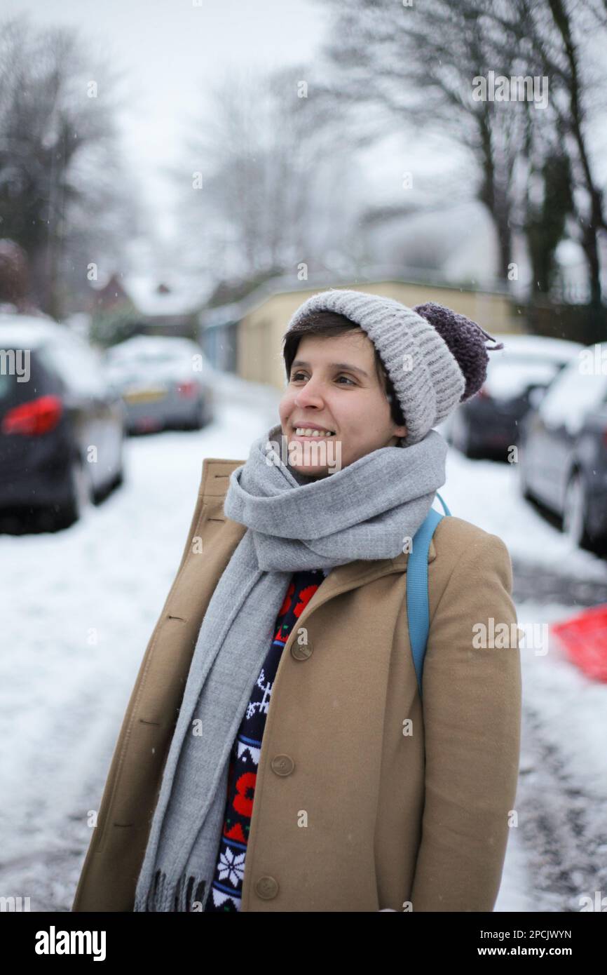 Giovane donna che cammina nella neve Foto Stock