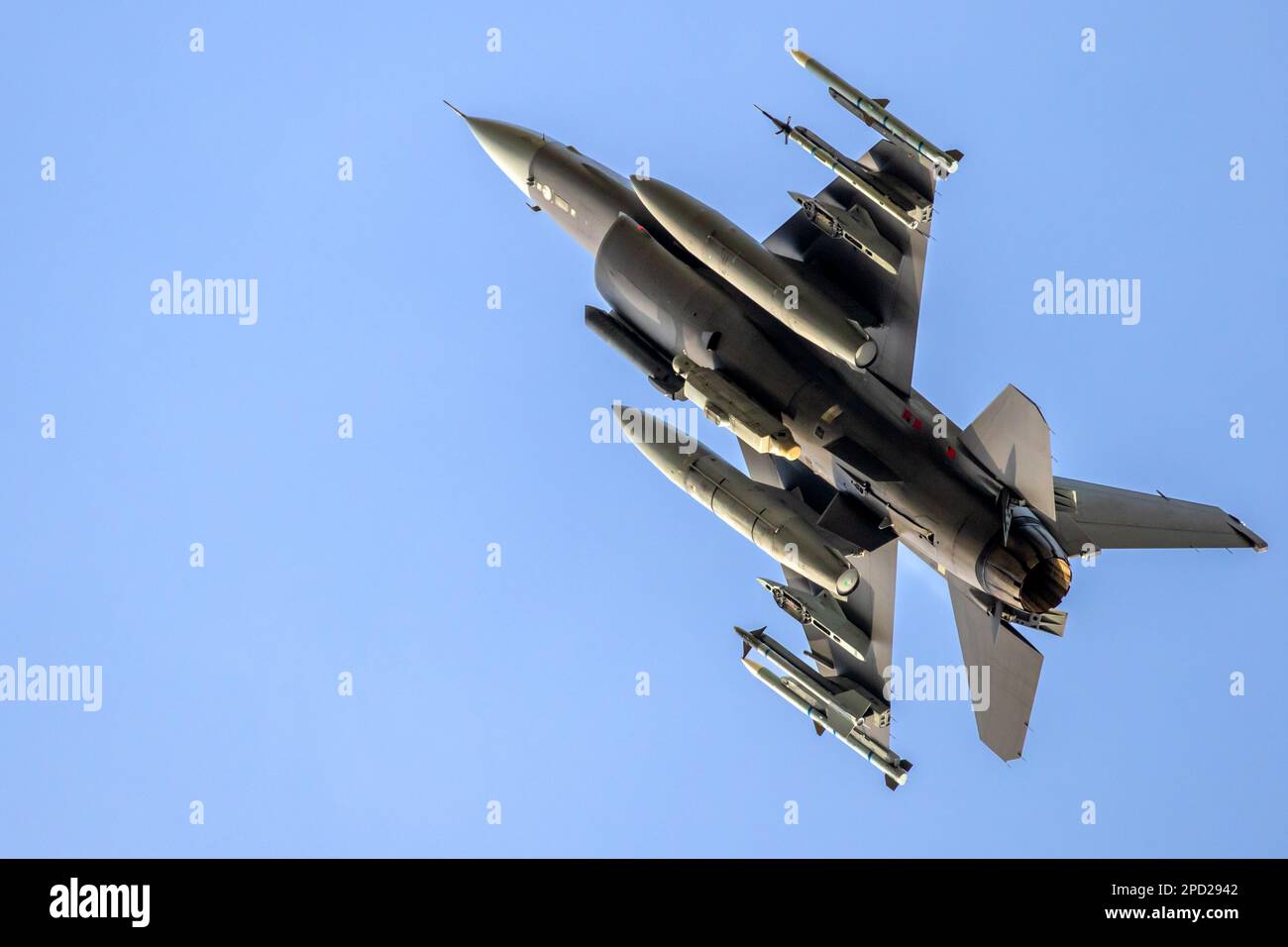 Il jet da combattimento militare armato prende il via su un cielo blu chiaro Foto Stock