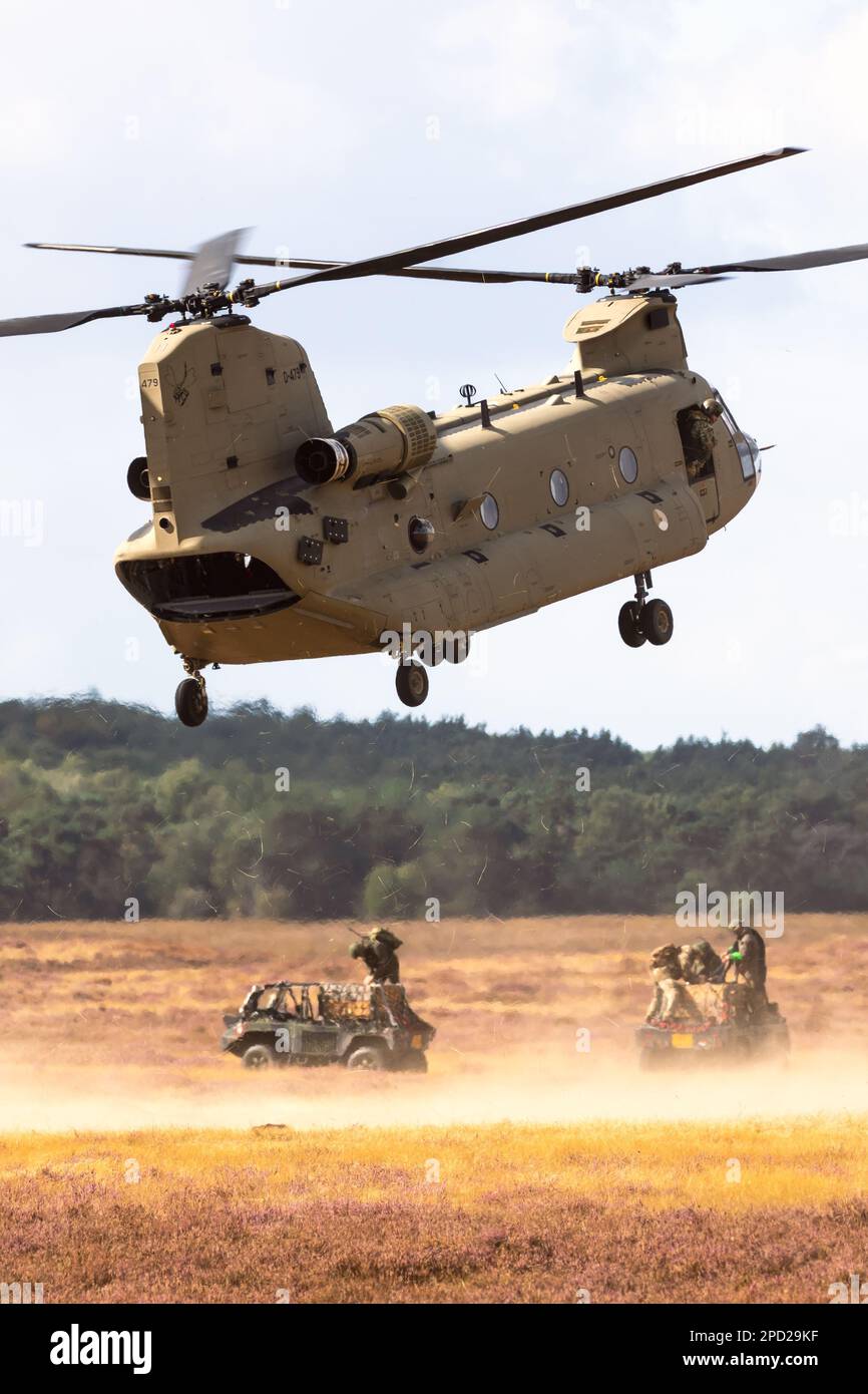 Soldati che attaccano un veicolo militare su tutti i terreni a un elicottero Boeing CH-47F Chinook. Ginkelse Heide, Paesi Bassi - 17 settembre 2022 Foto Stock
