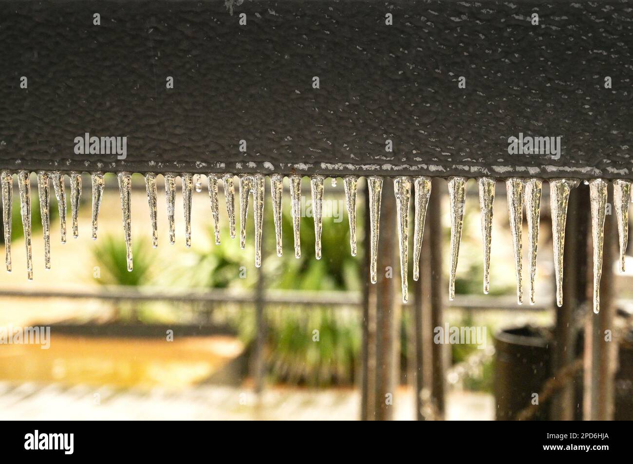 Fila di ciclicini sul fondo di un cartello in metallo dopo condizioni meteorologiche estreme e pioggia gelida. Nessuna gente. Foto Stock