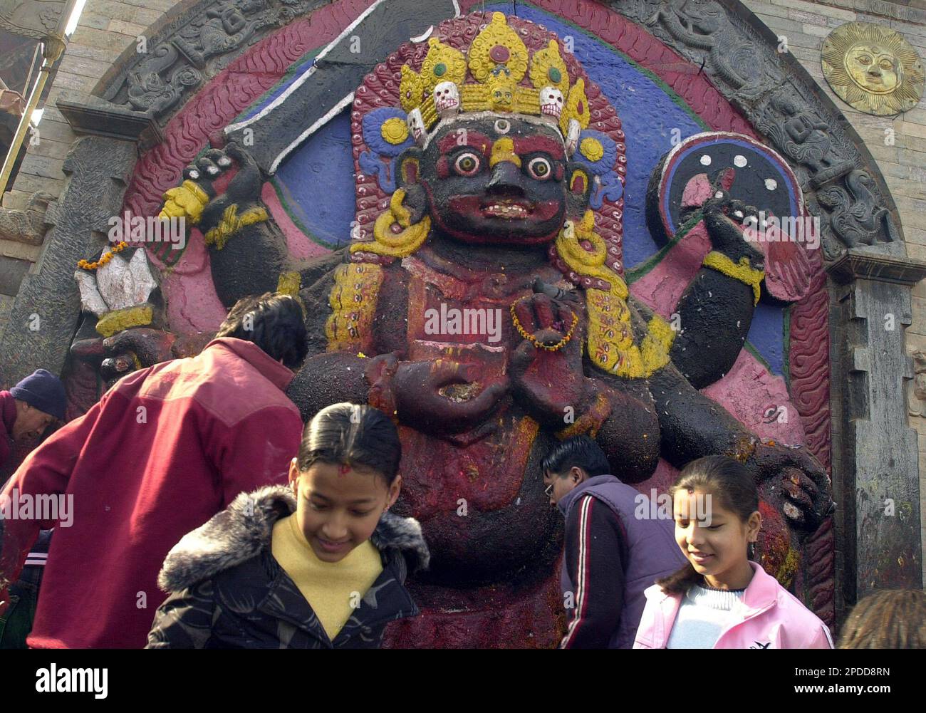 Nepali children seek blessings at the statue of Lord Bhairava, the