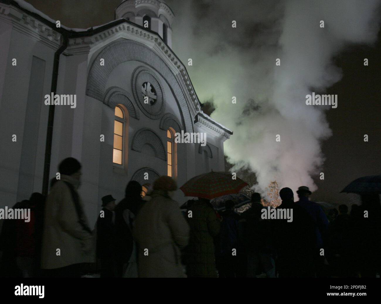 A group of Bosnian Serbs watch a ceremonial burning of dried oak