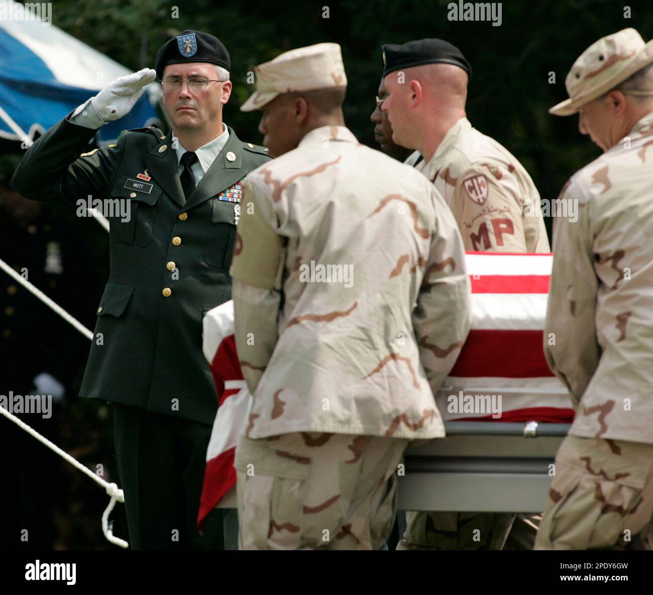 A U.S. Army Officer salutes as the casket of Staff Sgt. James D